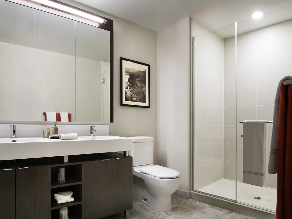 Master baths feature polished natural stone floors, with custom walnut vanities and oversized showers.