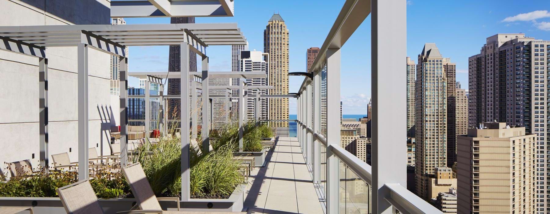 a walkway with chairs and tables on it and buildings in the background