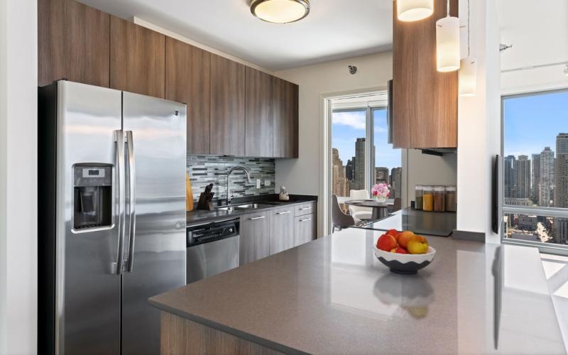 a kitchen with a stainless steel refrigerator