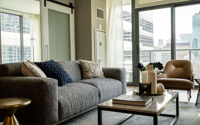 Cozy living room with ample lighting at State and Grand Apartments in Chicago, IL.