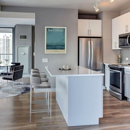 Kitchen with white cabinets at State and Grand apartments in River North, Chicago.	
