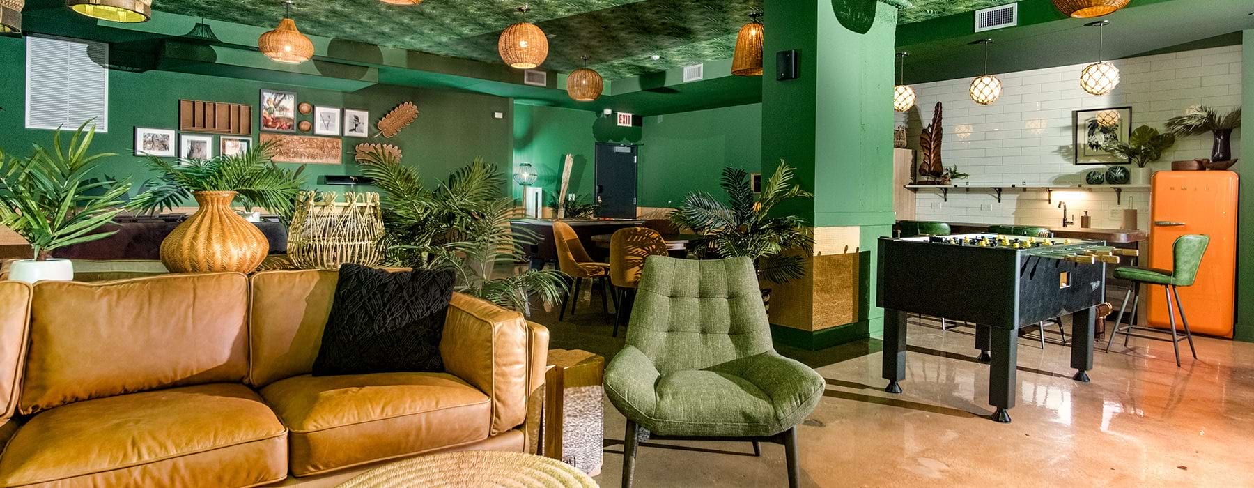 Bright colored common area with games, seating, and kitchen