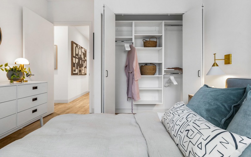 Bedroom with custom closets at The Saint Grand