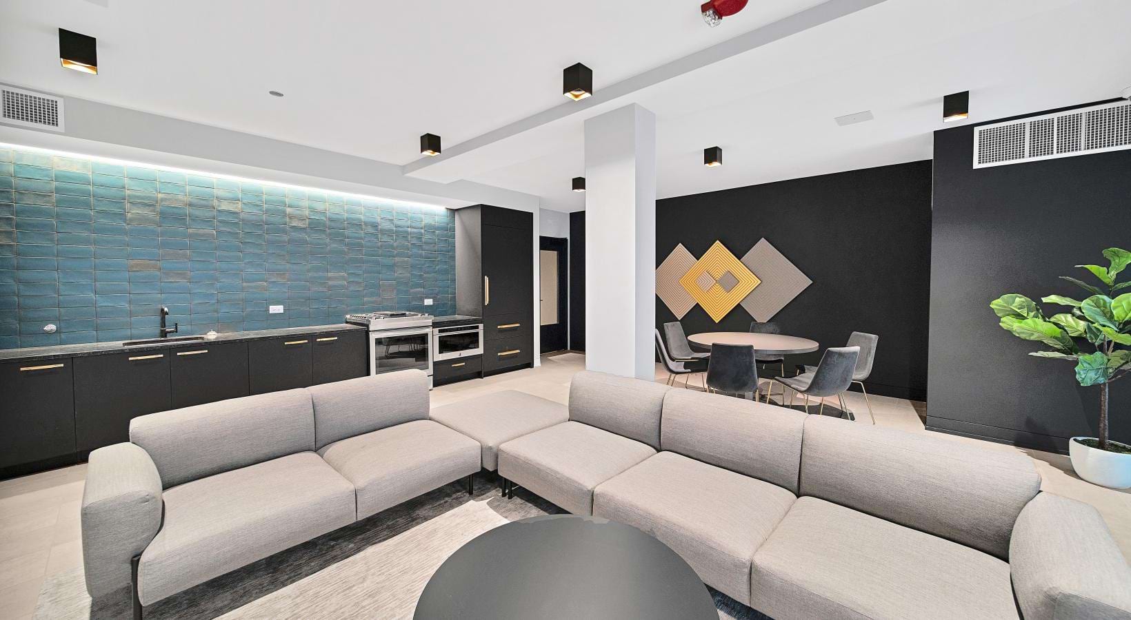 a clubhouse room with a couch and chairs