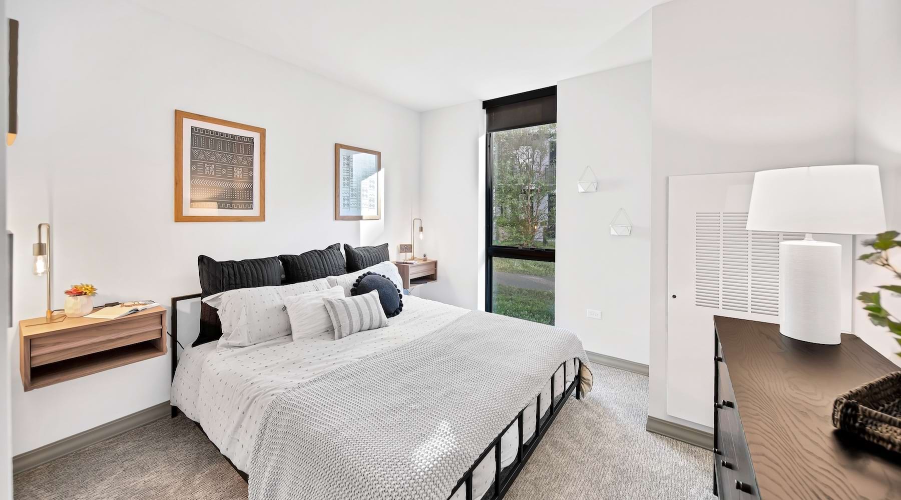a bedroom with a bed and two nightstands