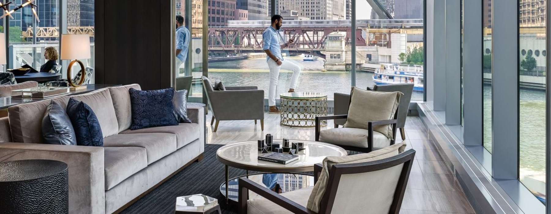 clubhouse surrounded by floor-to-ceiling windows and views of the river